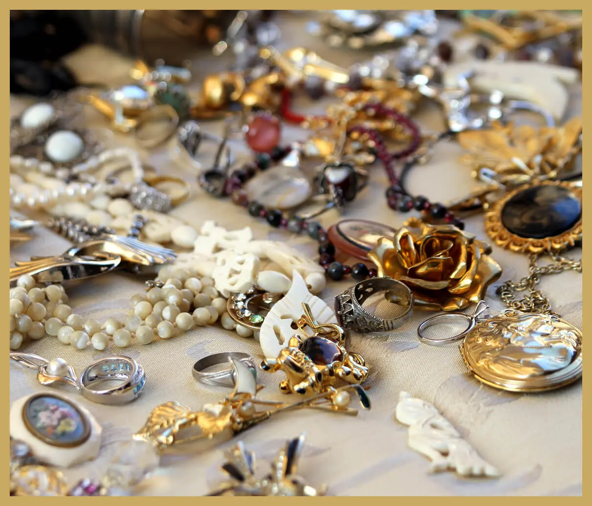 Assorted jewelry pieces on a soft surface.