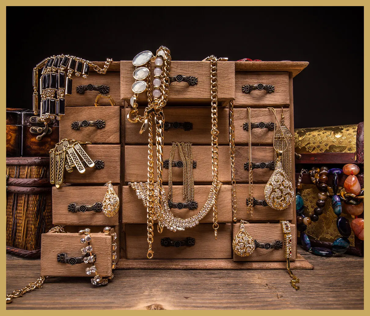 Jewelry displayed on wooden drawers and boxes.