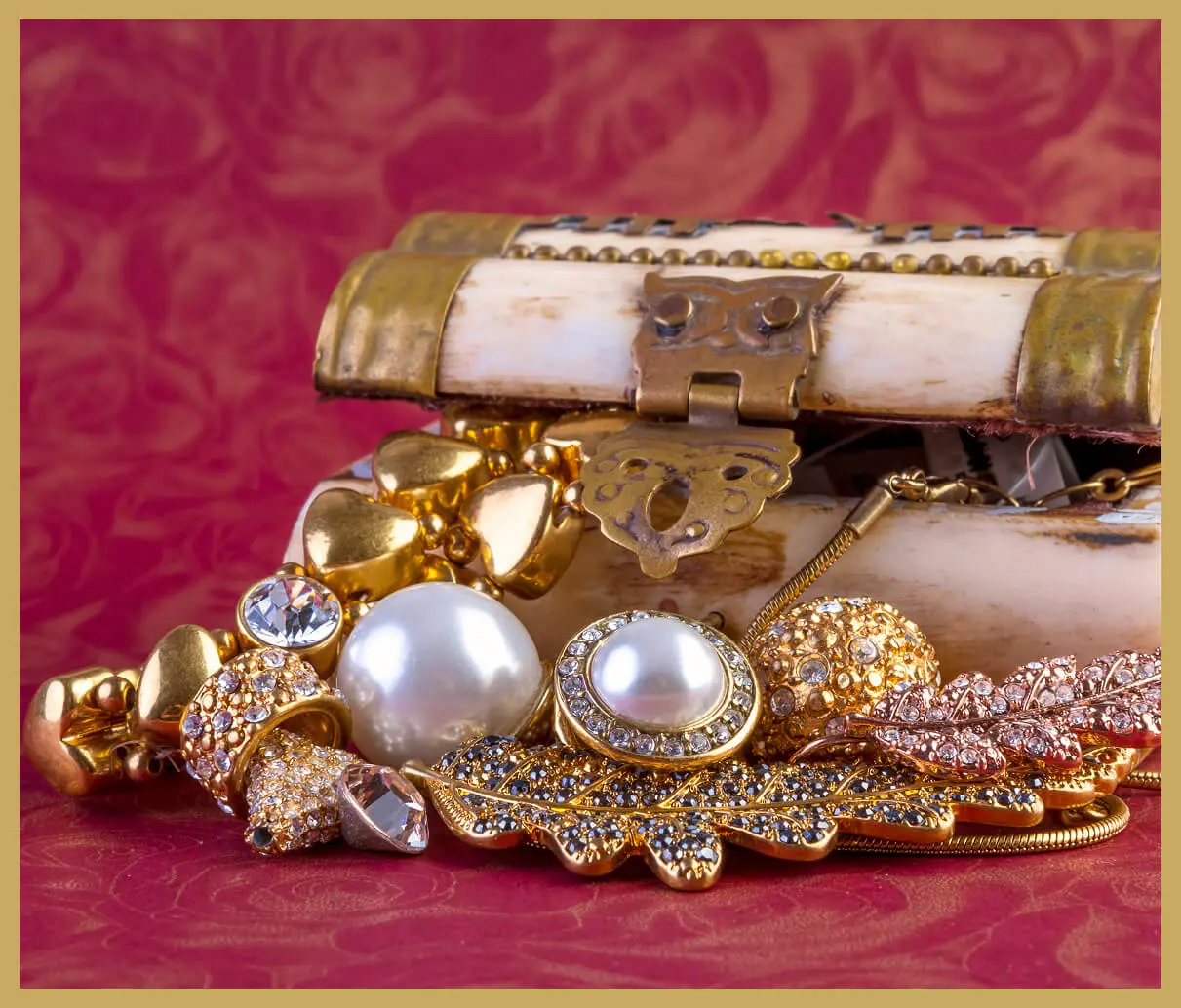 Ornate jewelry spilling from decorative chest.