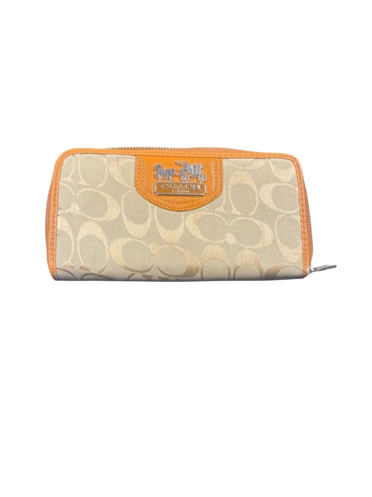 Beige and orange Coach wallet on white.