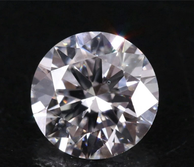 Sparkling round-cut diamond on dark background.